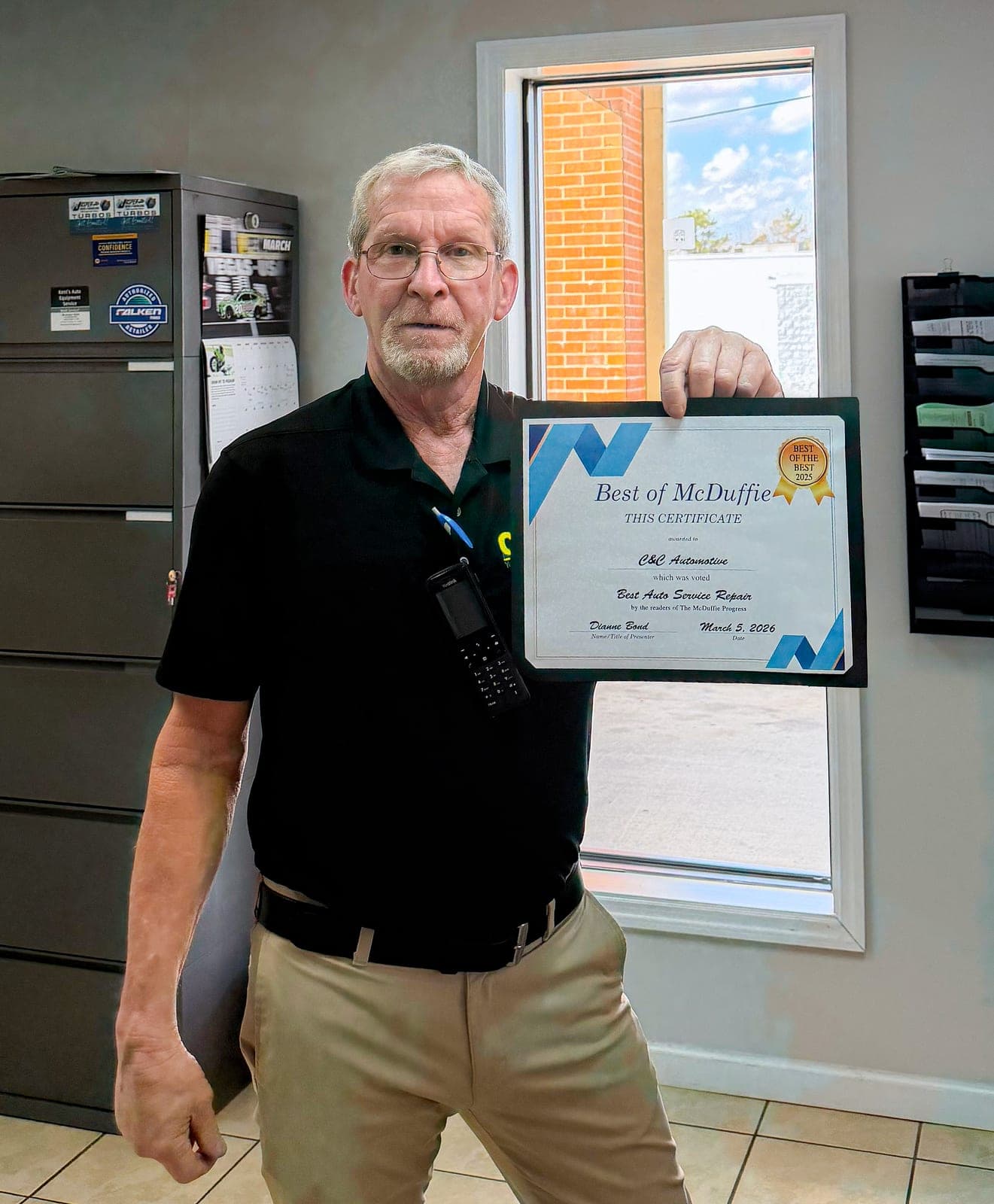 C&C Automotive Thomson service advisor holding the Best of McDuffie certificate for Best Auto Service Repair