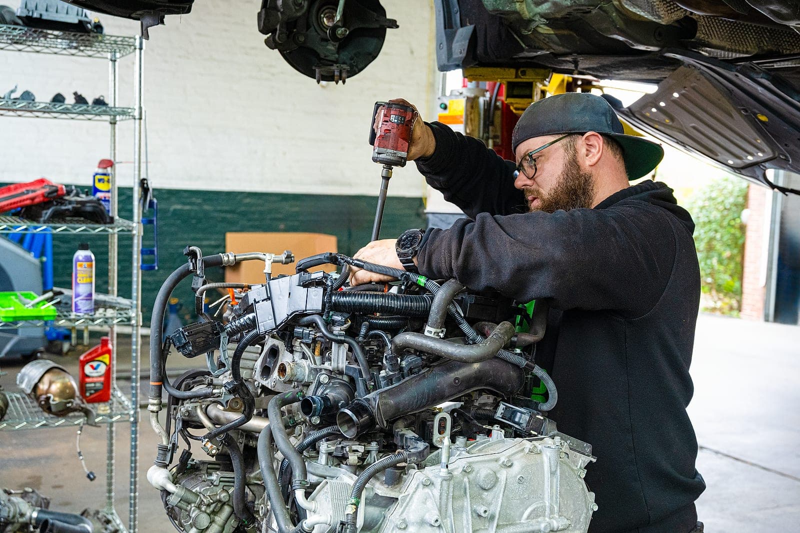 C&C Automotive technician performing engine repair on a vehicle in the Downtown Augusta service bay.