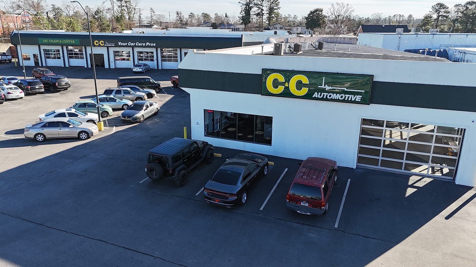 Elevated view of the C&C Automotive Martinez shop on Washington Road, showing the oil change center bays and the customer lot.