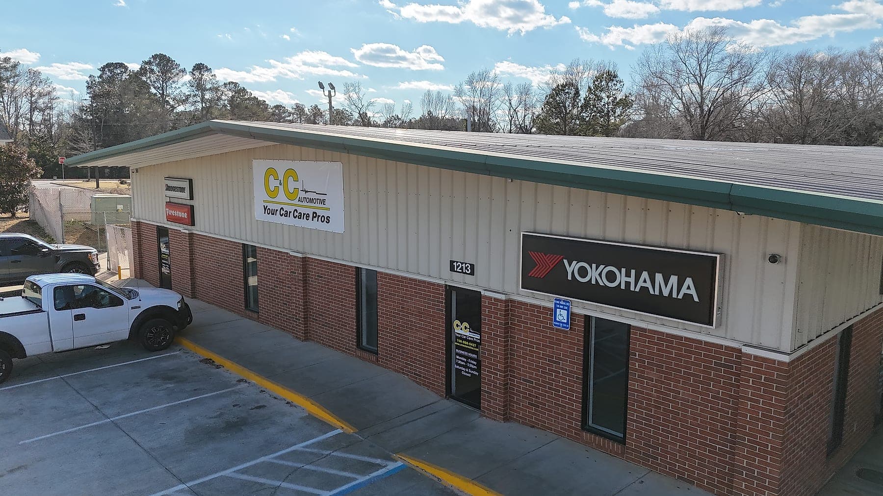 Aerial view of the C&C Automotive Thomson shop on Washington Road, showing the brick storefront and Yokohama tire signage.
