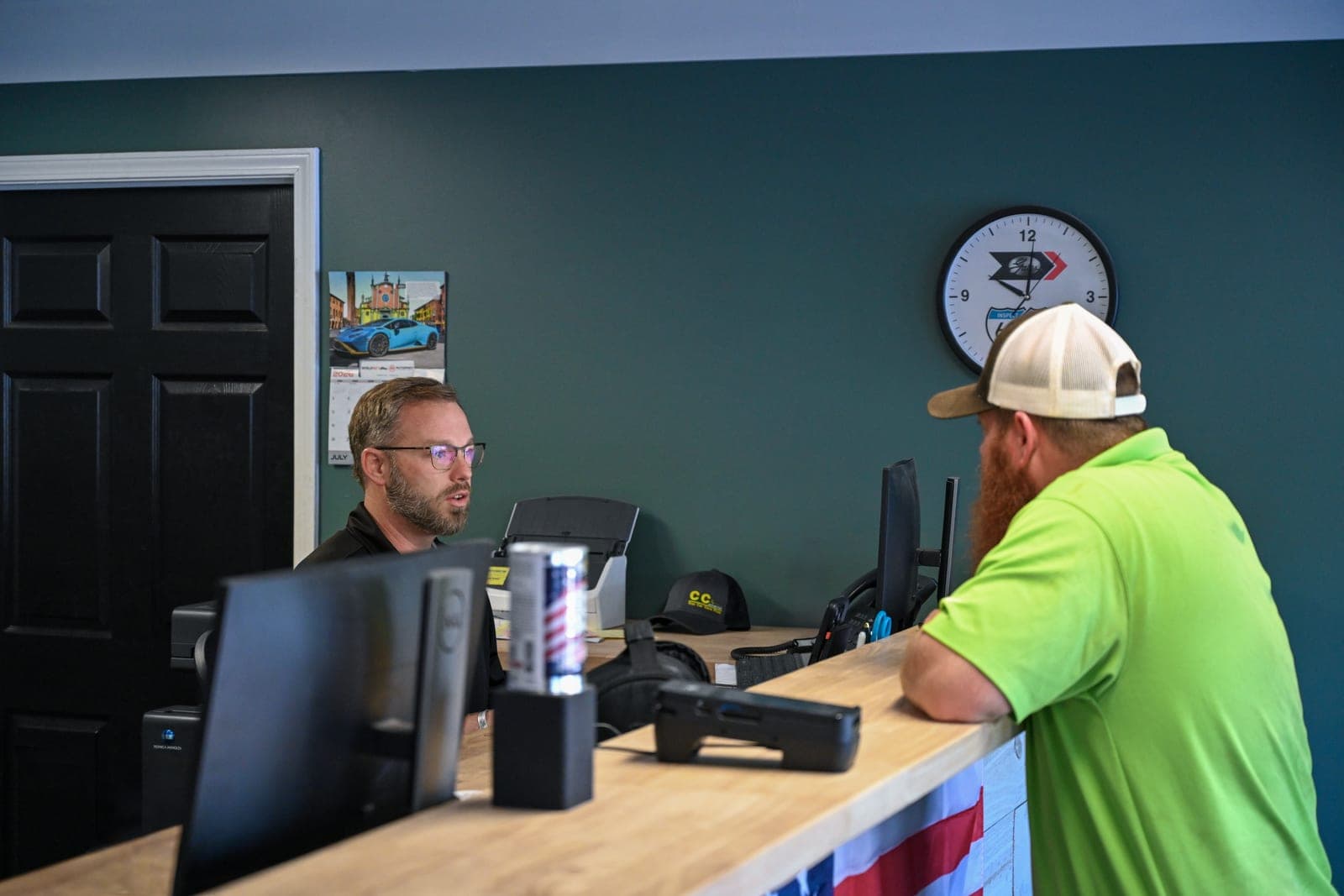 A service advisor helping a customer at the Warrenville front counter.