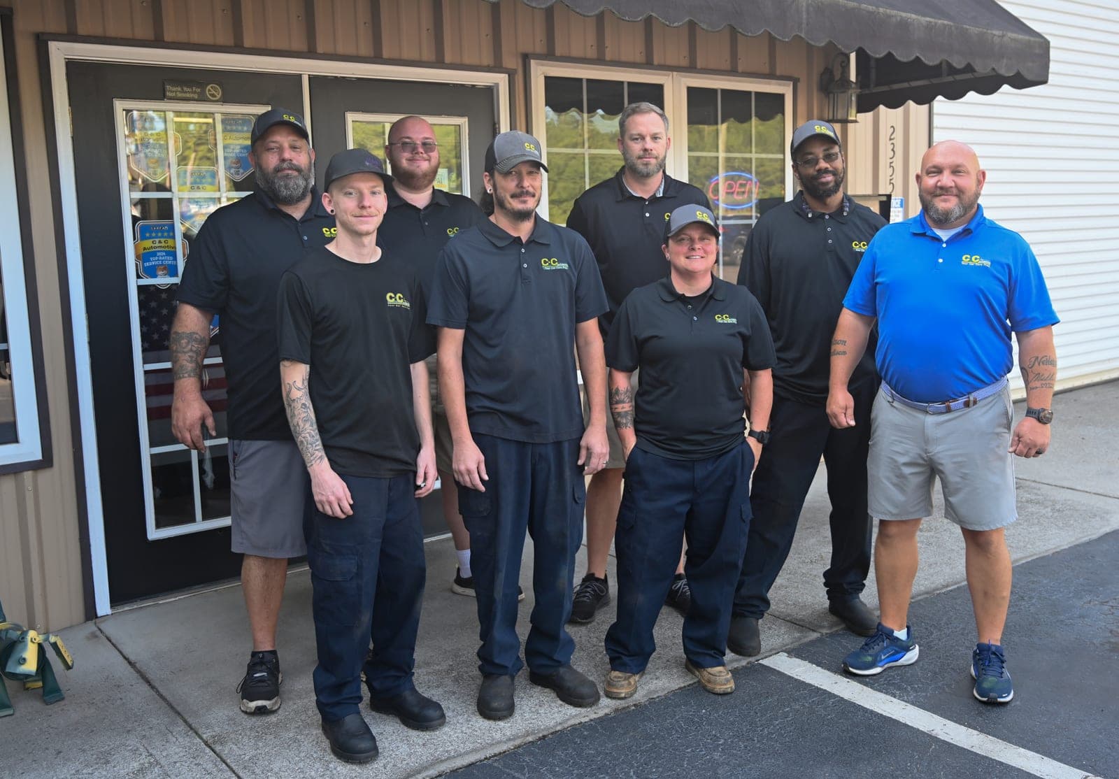 The C&C Automotive Warrenville team gathered outside the shop entrance in their shop polos, July 2026.