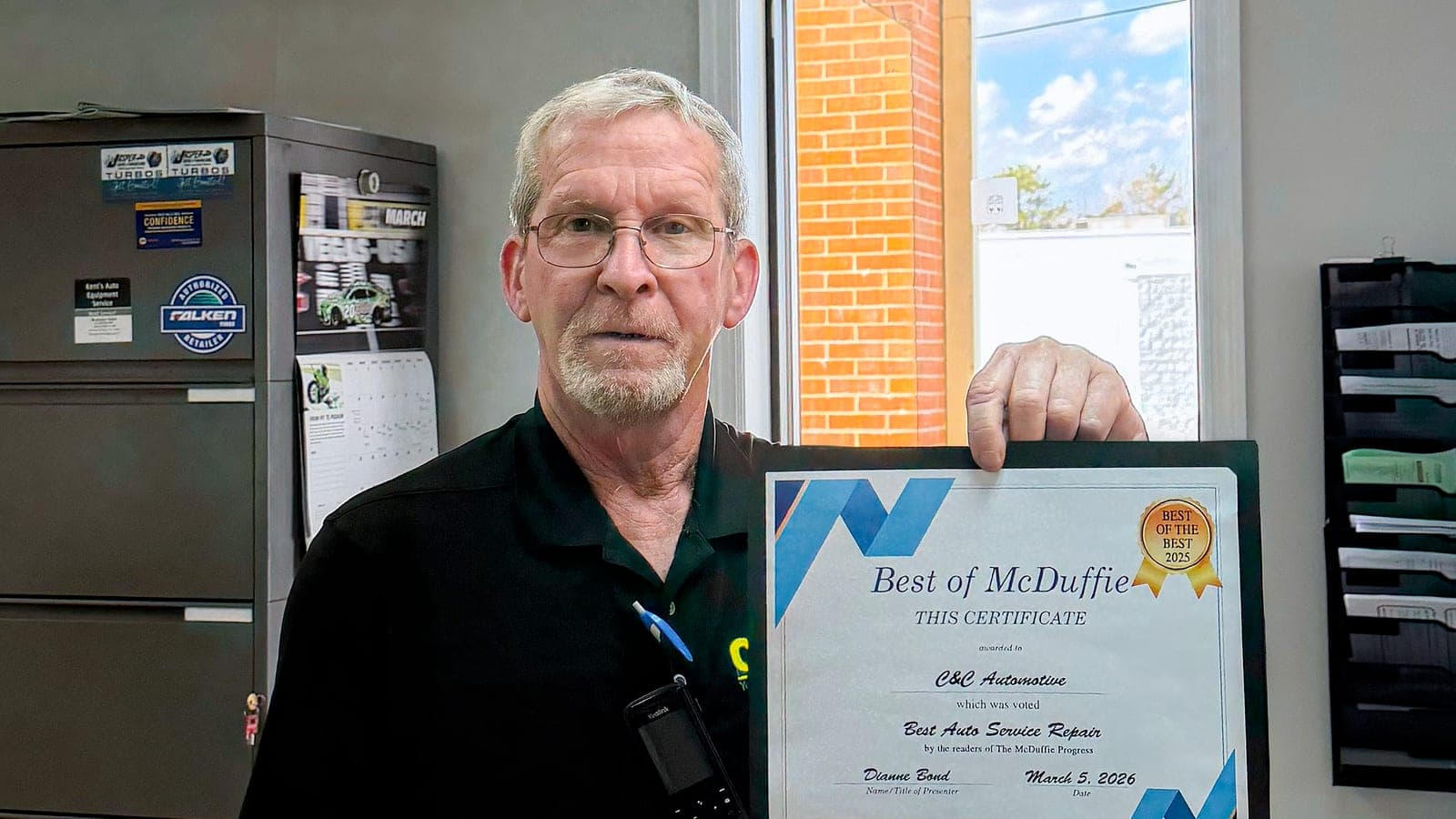 C&C Automotive Thomson team member holding the Best of McDuffie certificate for Best Auto Service Repair