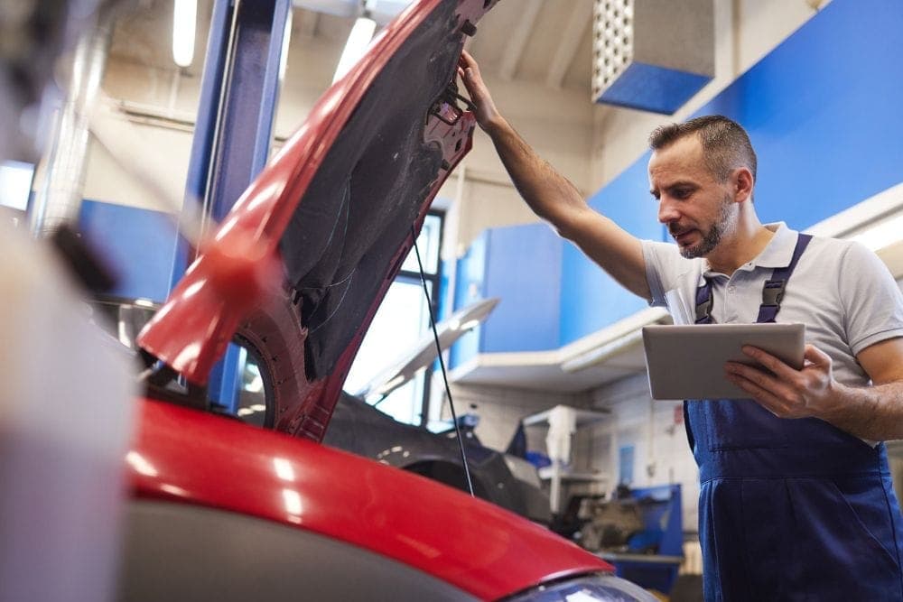 Mechanic inspecting a used vehicle before purchase