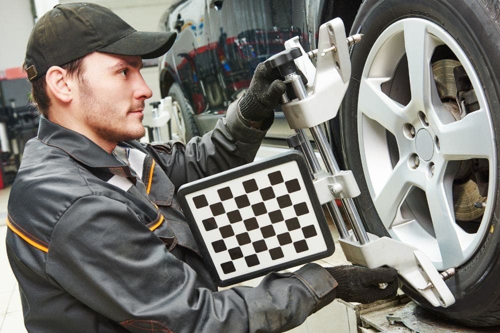 Vehicle wheel alignment in progress at the auto shop