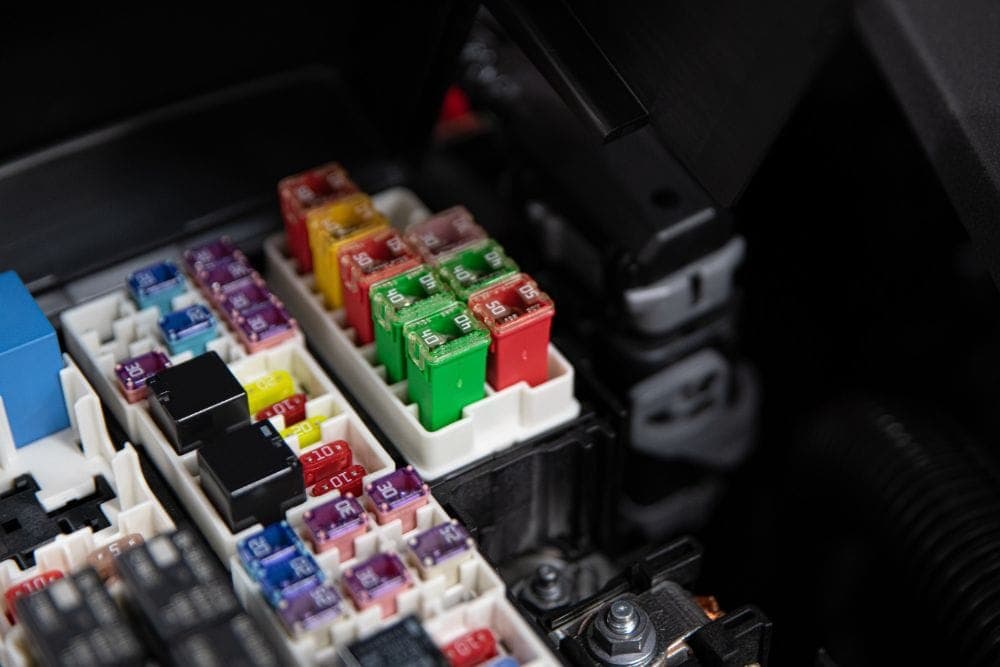 Technician diagnosing a vehicle electrical system